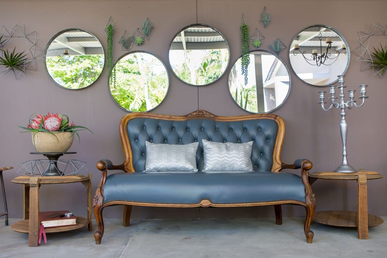 Covered patio lounge with round mirrors at Vin Boho Guesthouse