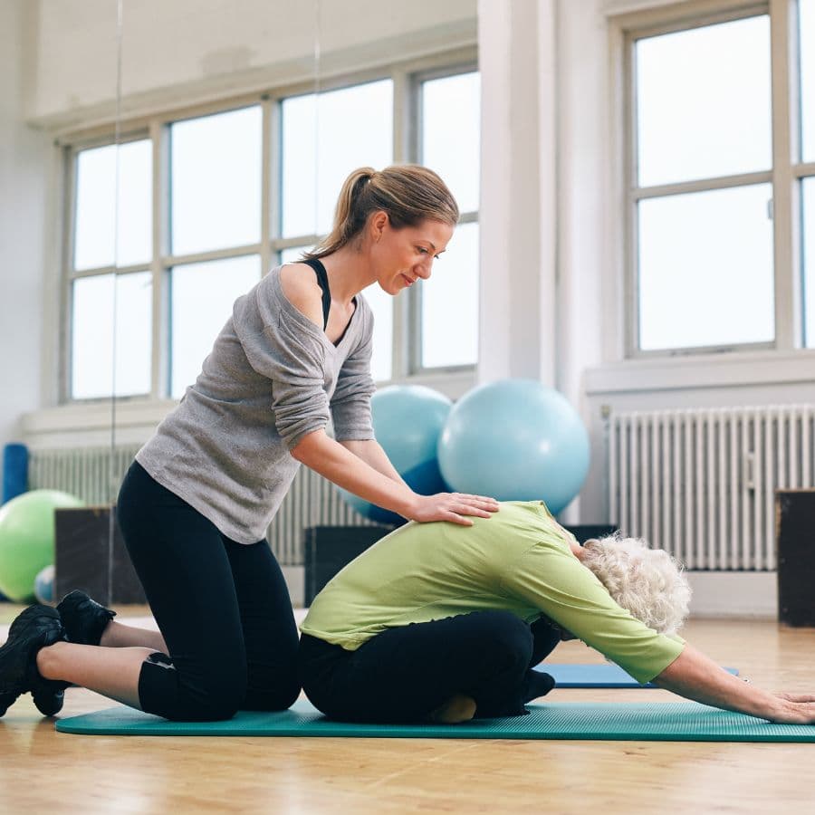 Student using a strap for a supported stretch
