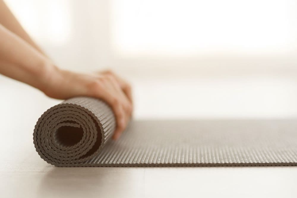 Hands resting in prayer position at the end of a yoga class